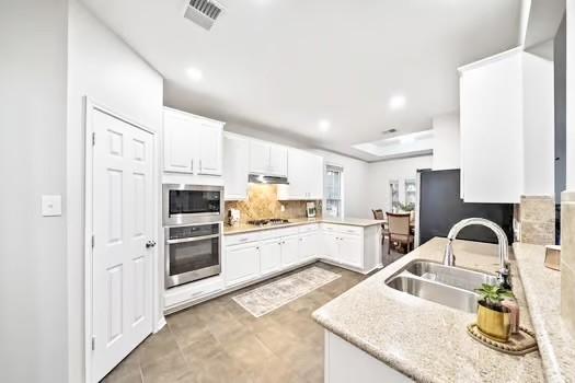 Image 3: Kitchen opening to the living space