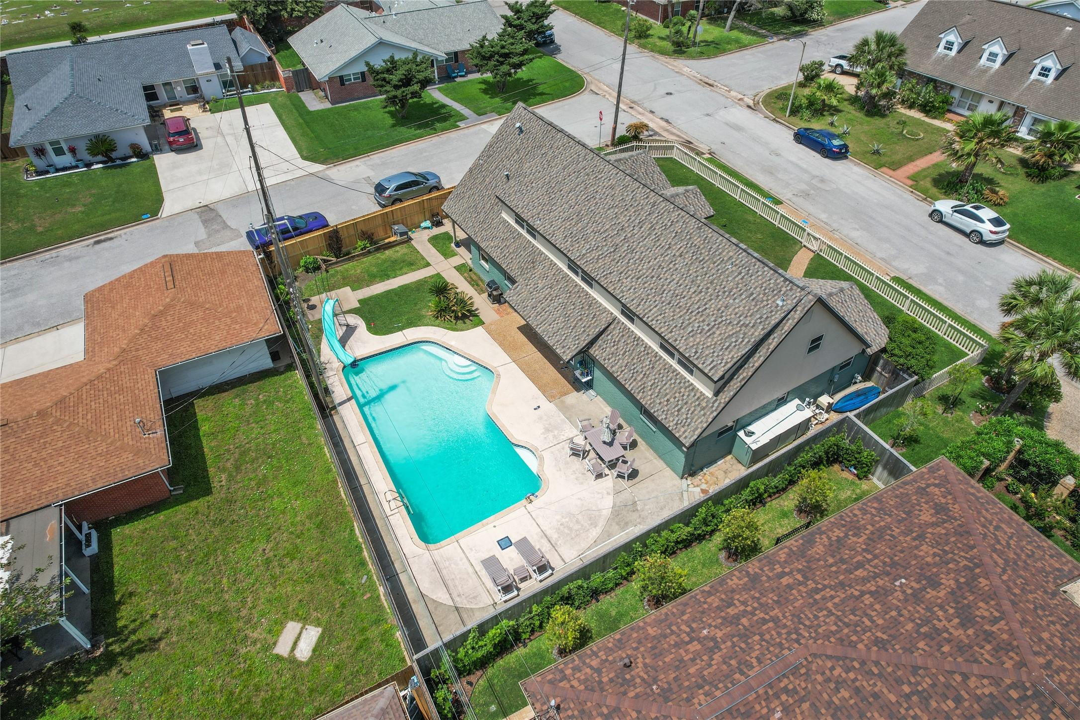 Image 1: This aerial photo showcases a well-maintained home