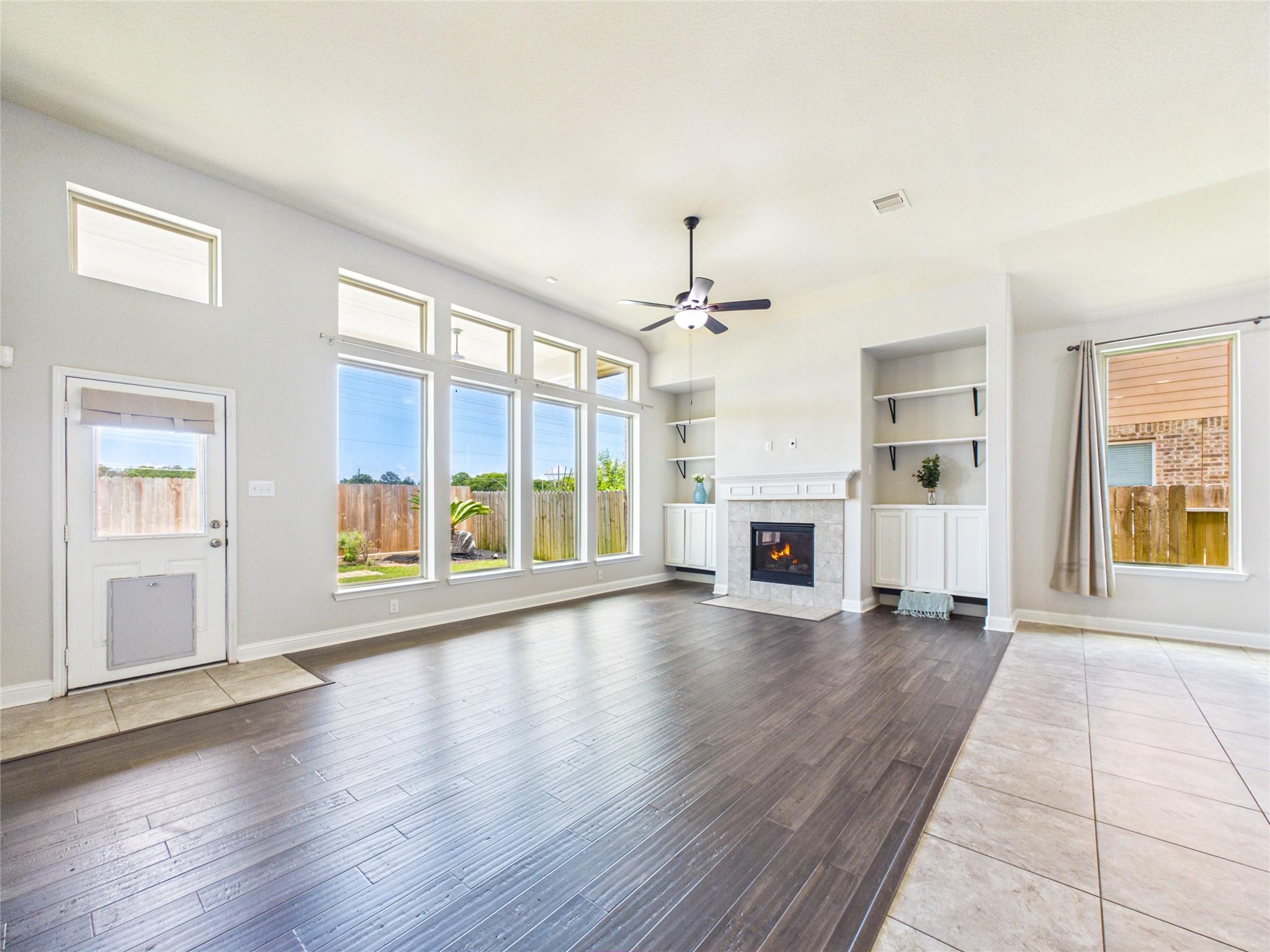 Image 3: This spacious living area features a cozy fireplac