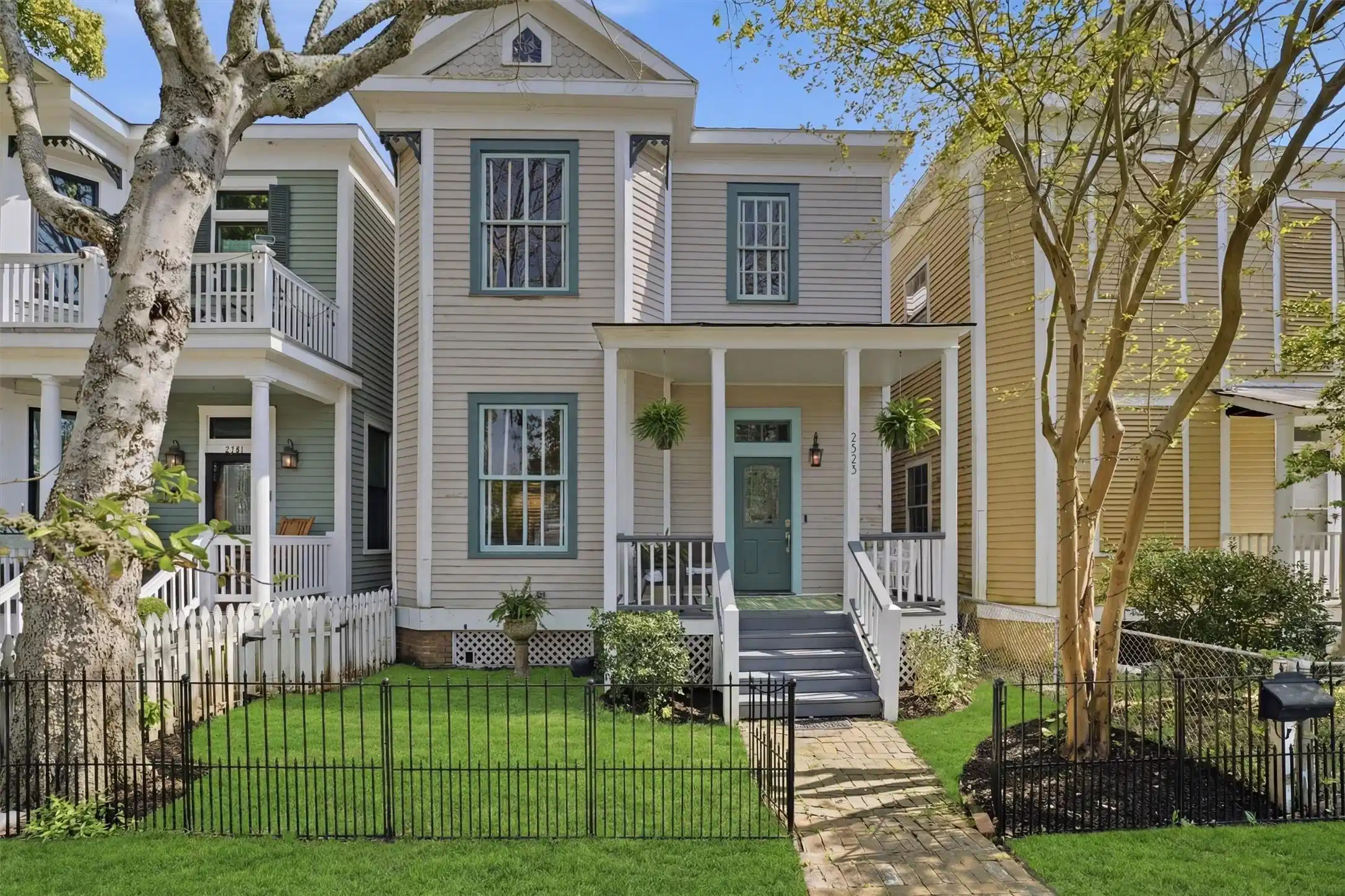 Image 1: Classic Victorian exterior with covered porch, mat