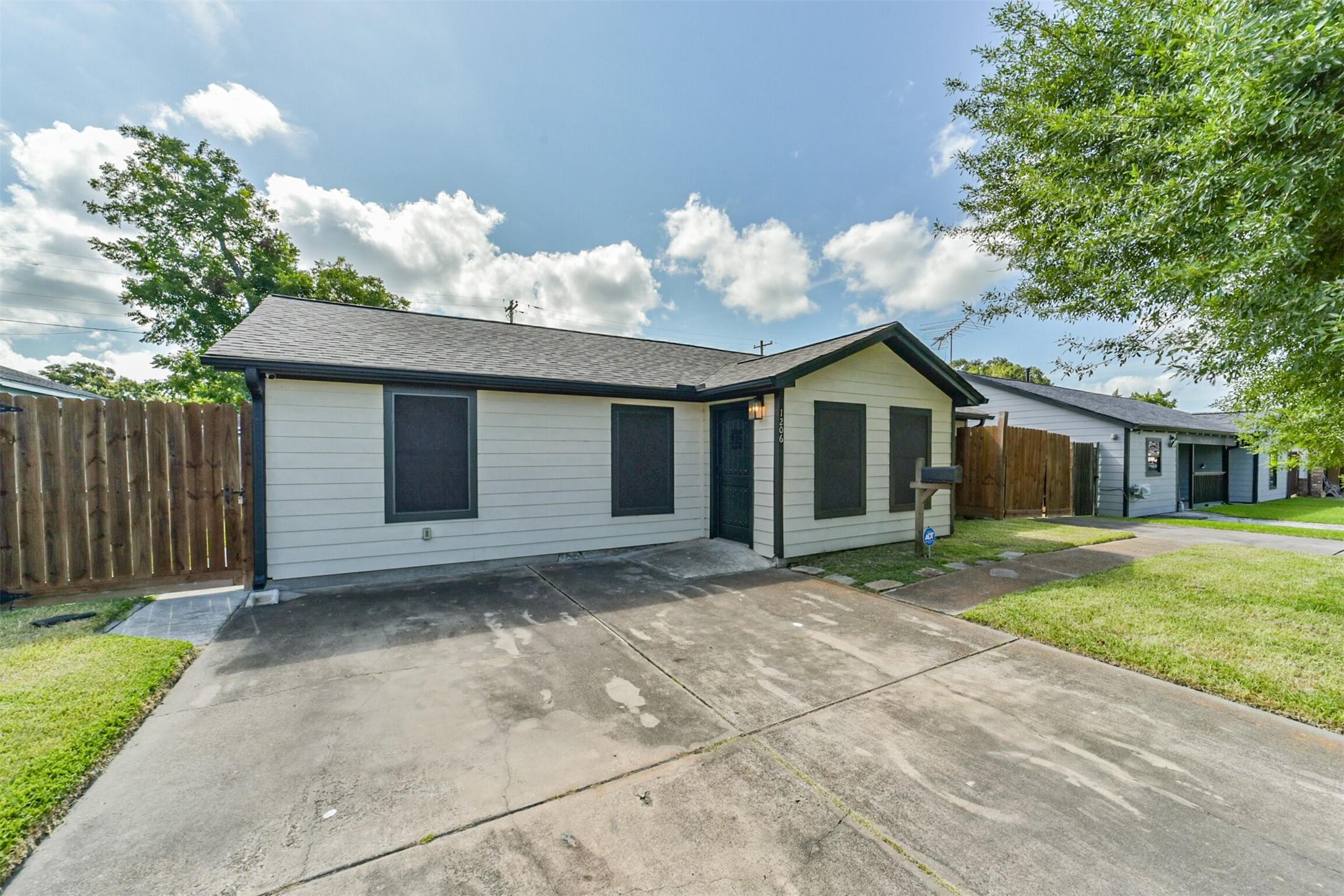 Image 2: Singe-story home with a clean, modern exterior, fe