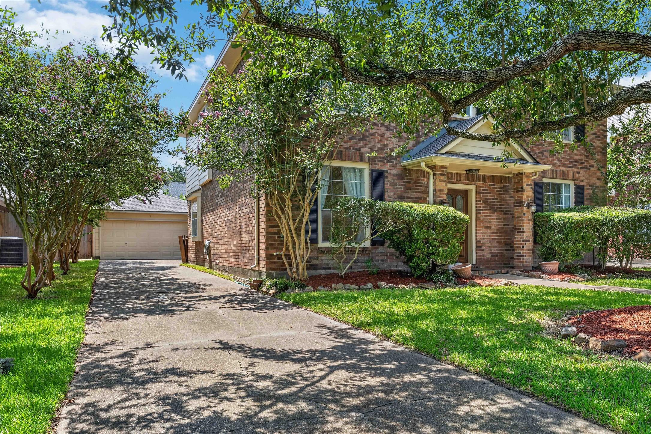 Image 2: Charming brick home with a welcoming front porch,