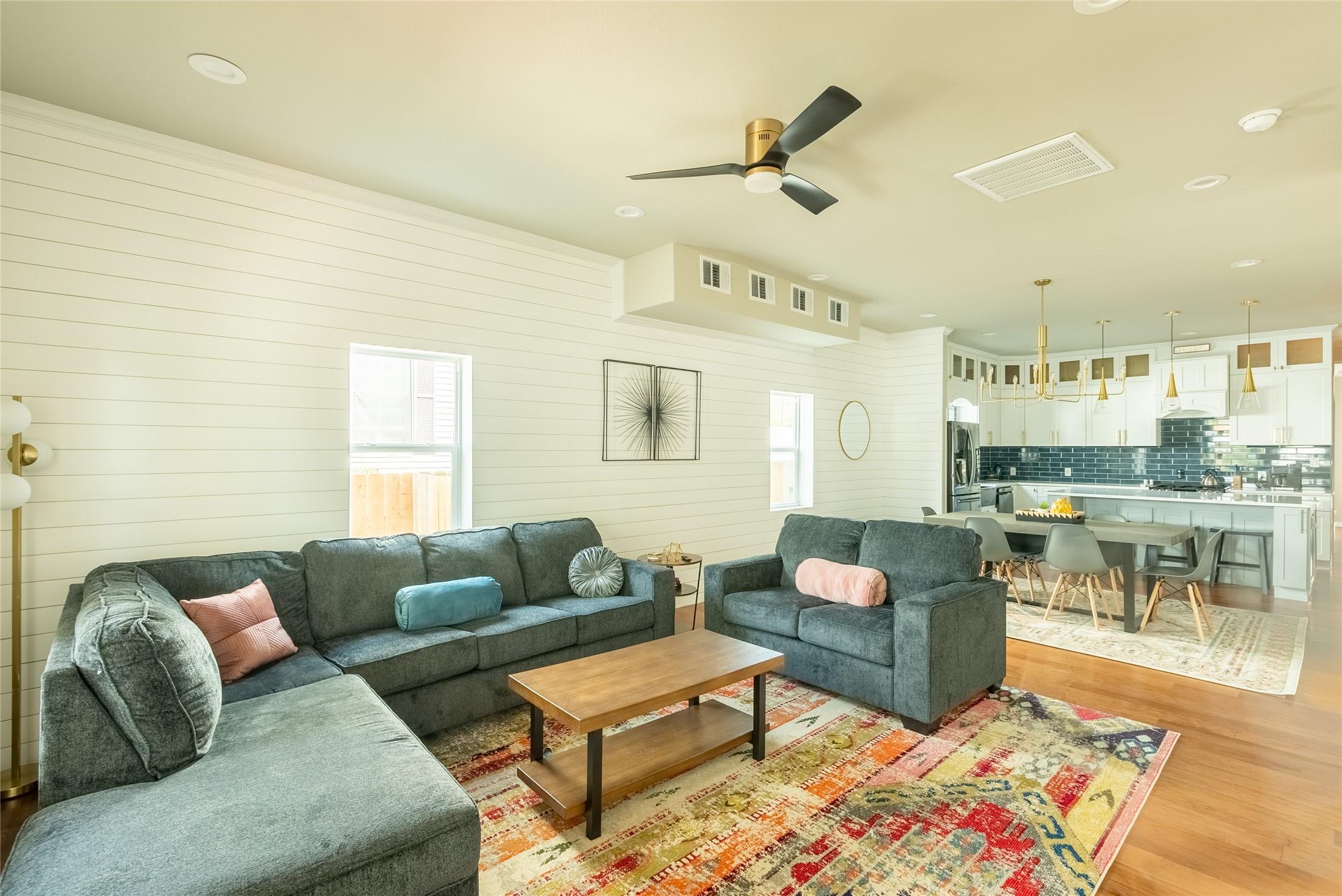 Image 4: The spacious living room is open to the kitchen an