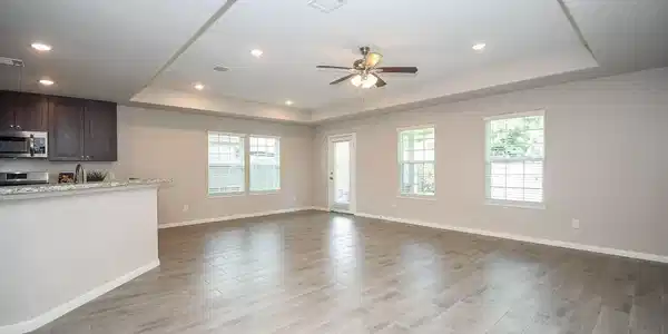 Image 4: Large living/dining area with wood look tile throu
