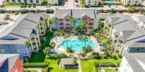 Image 4: A resort style pool offers a spacious setting for