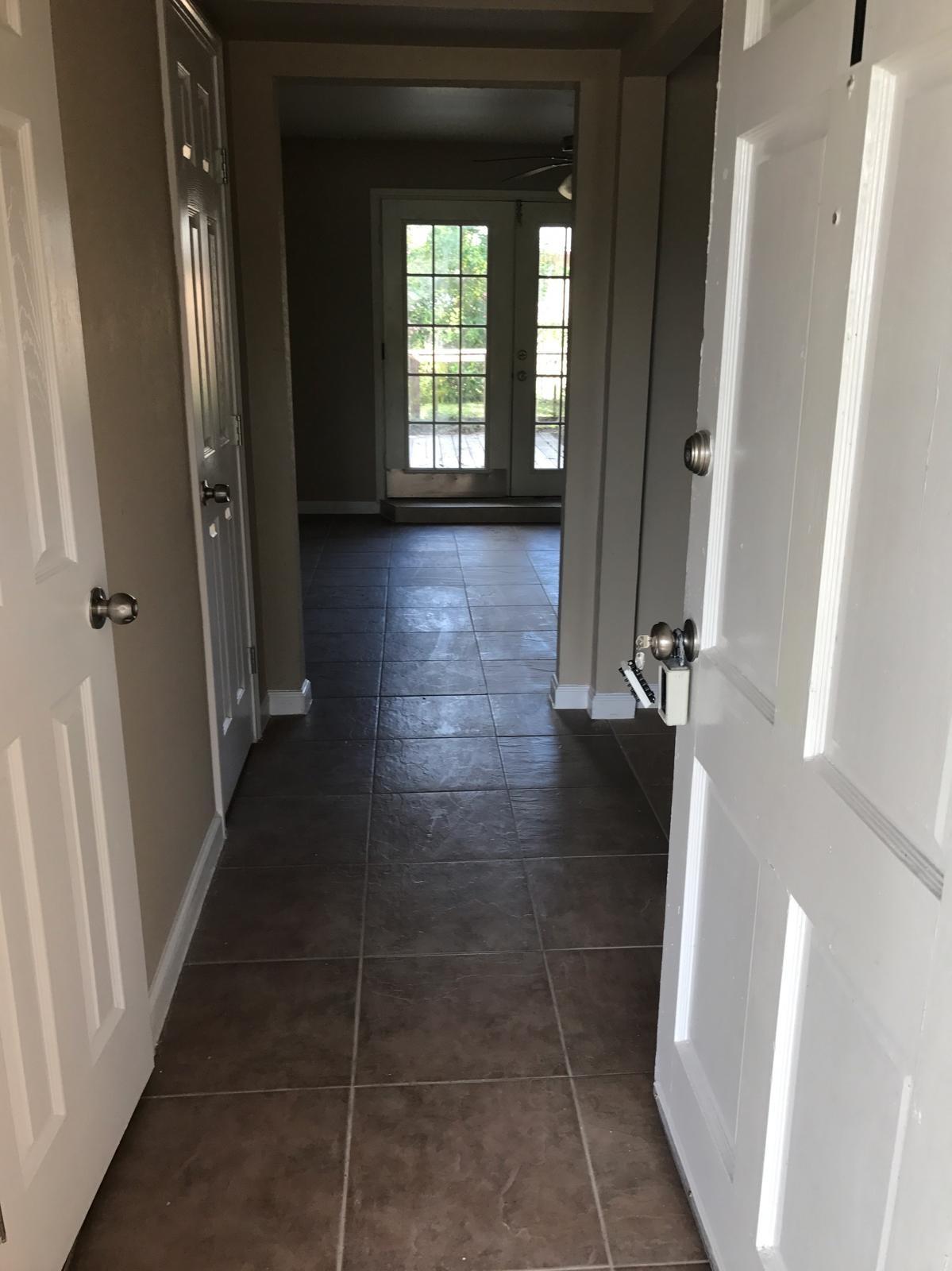 Image 2: Hallway entry with Living room on right and half b