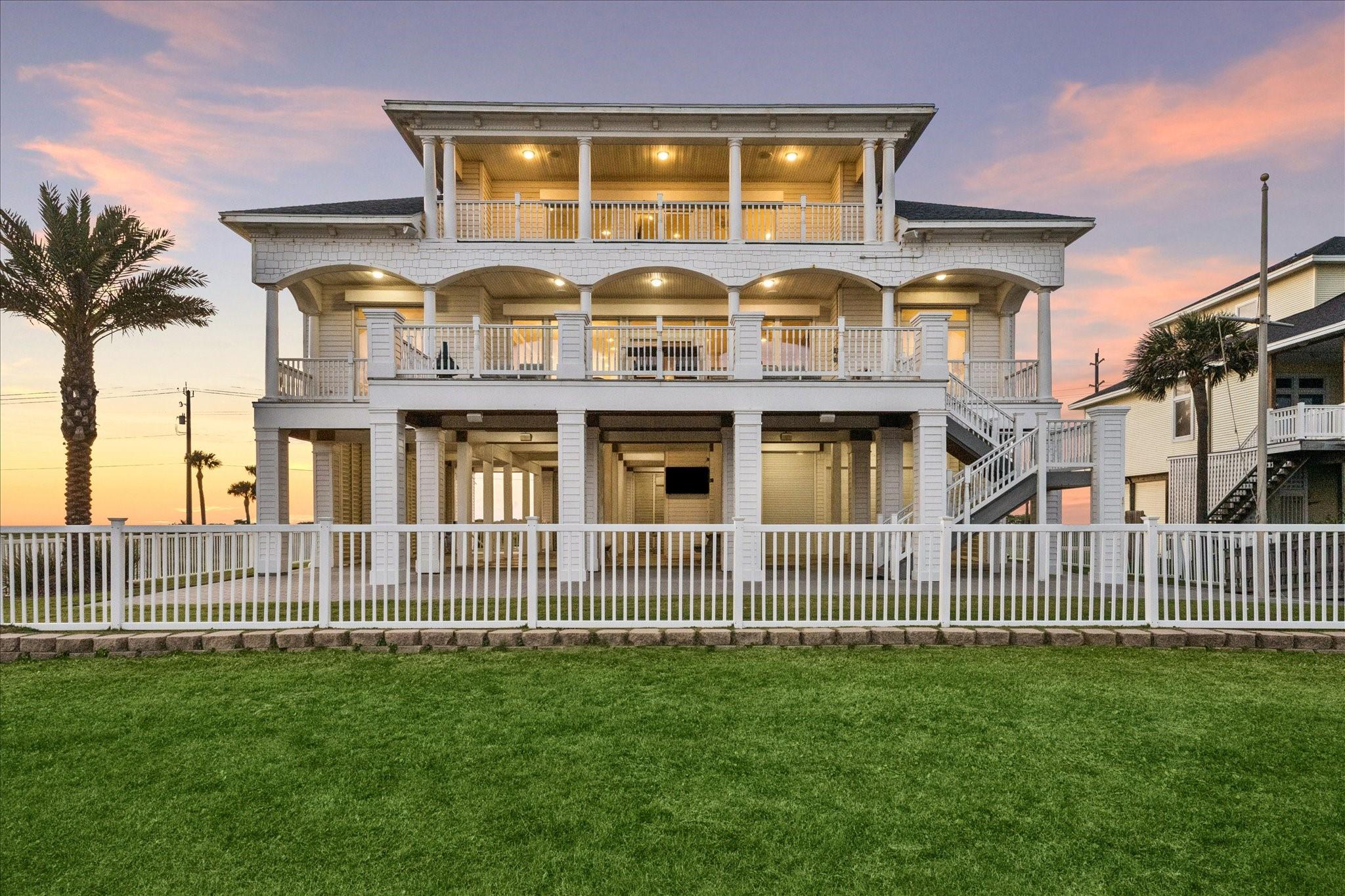 Image 2: Designed for effortless coastal living, the rear o
