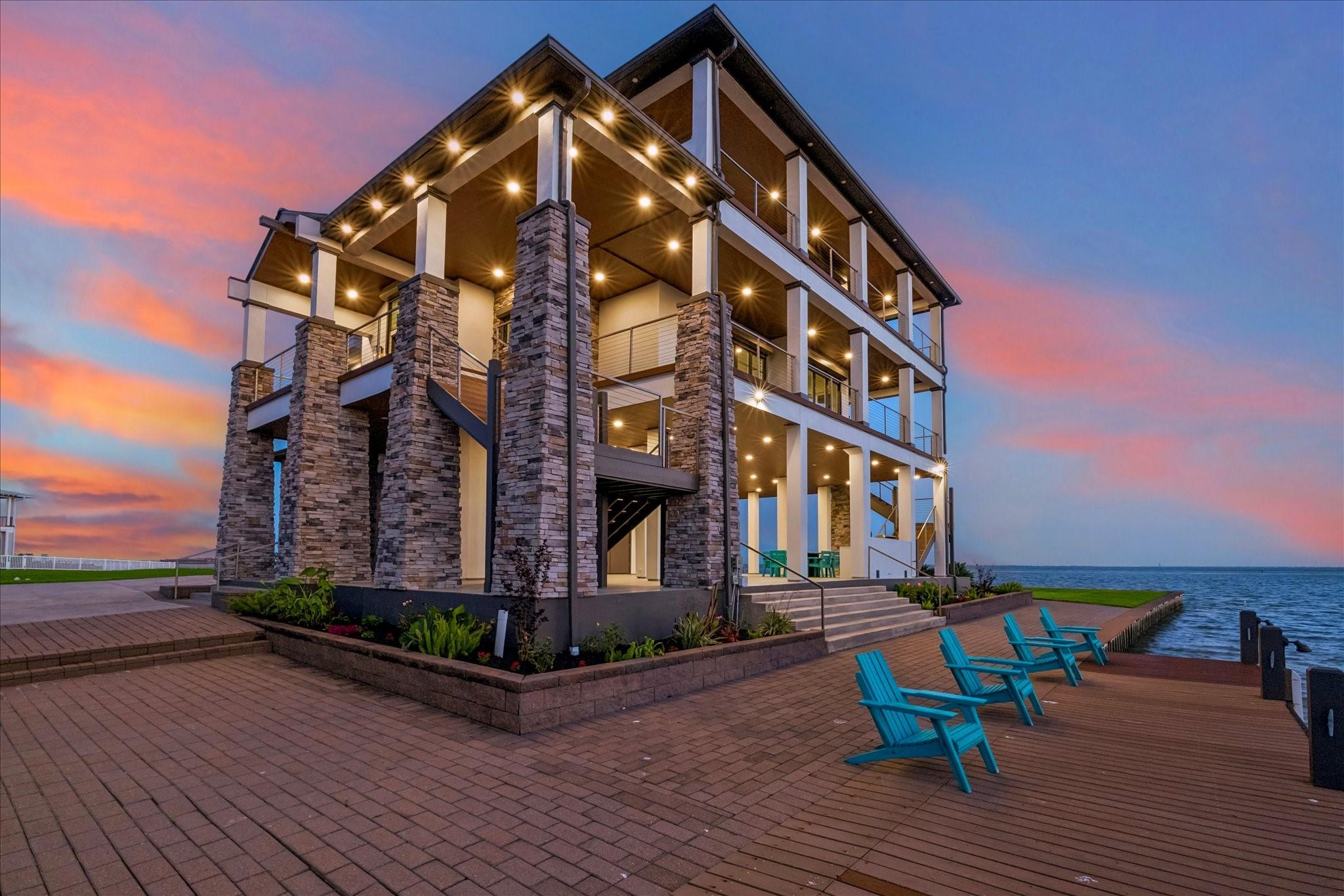 Image 4: Elegant paver stone walkways surround the home, de