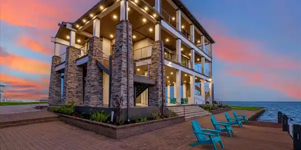 Image 4: Elegant paver stone walkways surround the home, de
