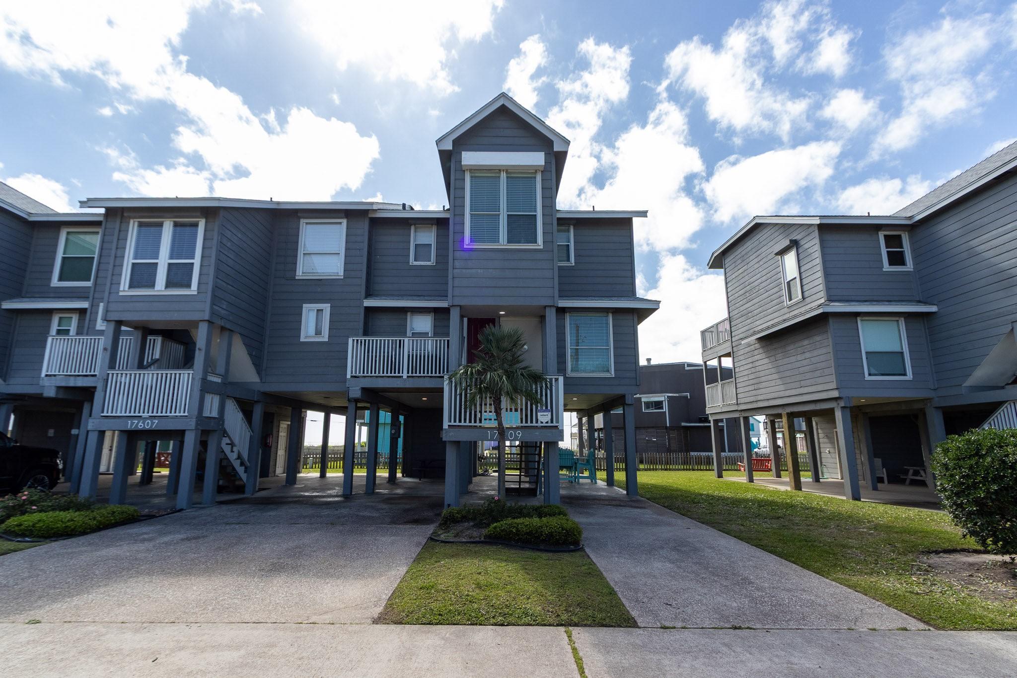 Image 3: This photo shows a modern stilted home with a gray