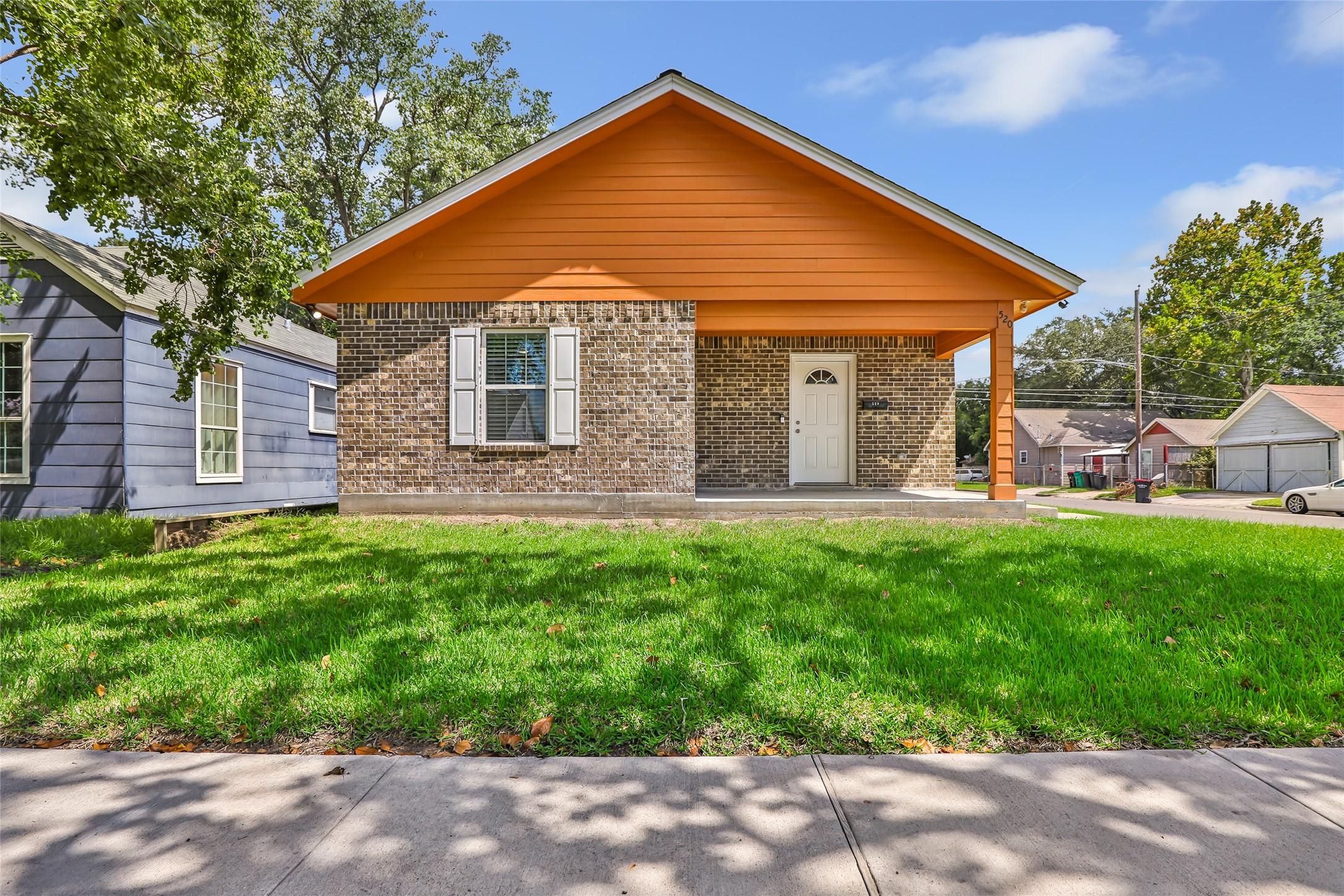 Image 1: Street view of the front of the home