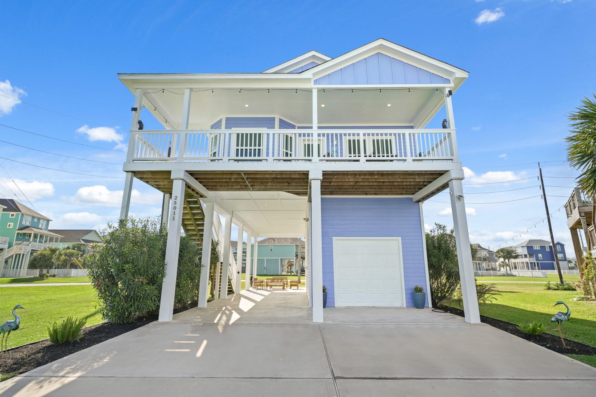 Image 2: This elevated, modern coastal home features a spac