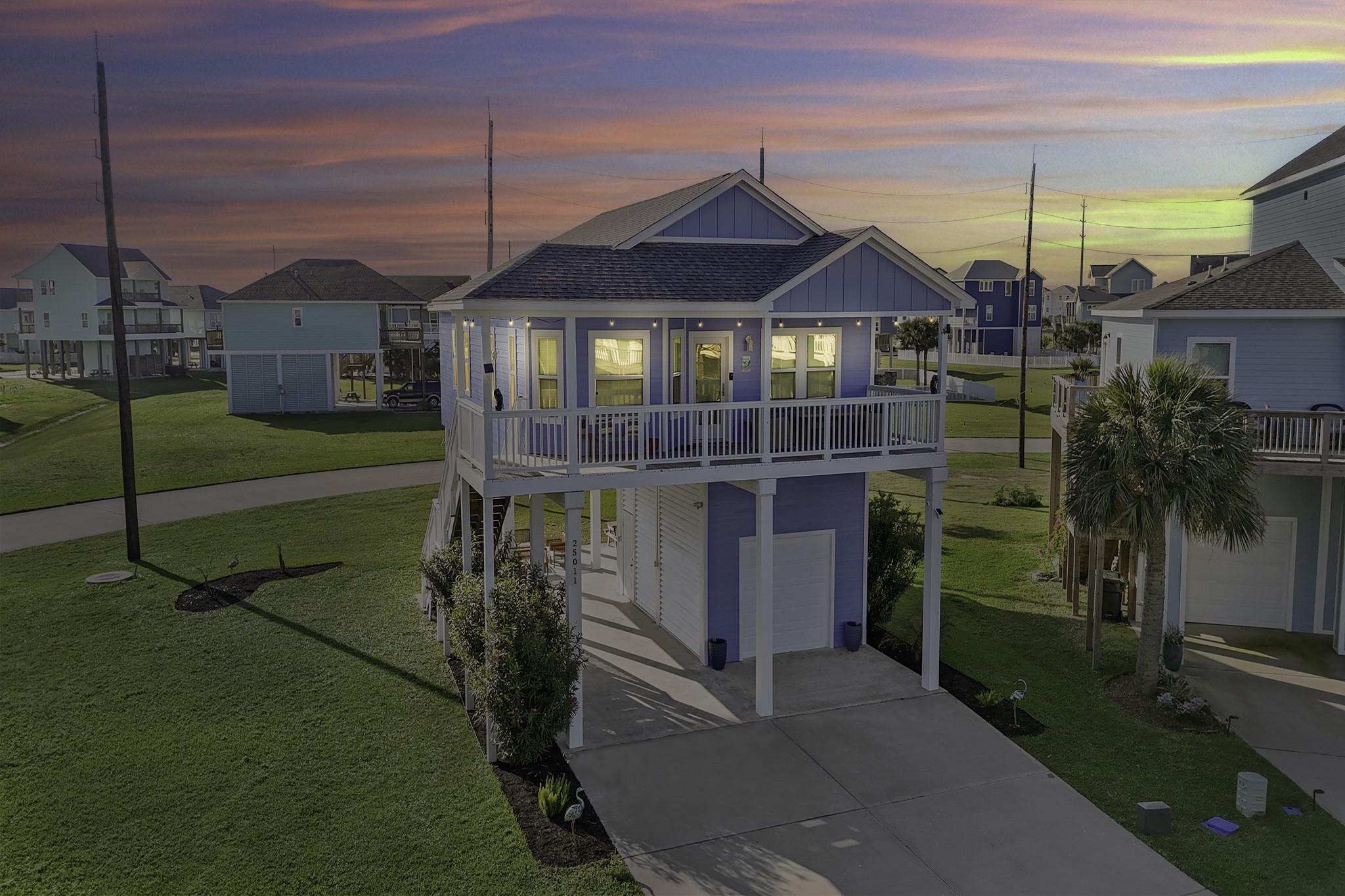 Image 3: Elevated modern coastal home with a spacious balco