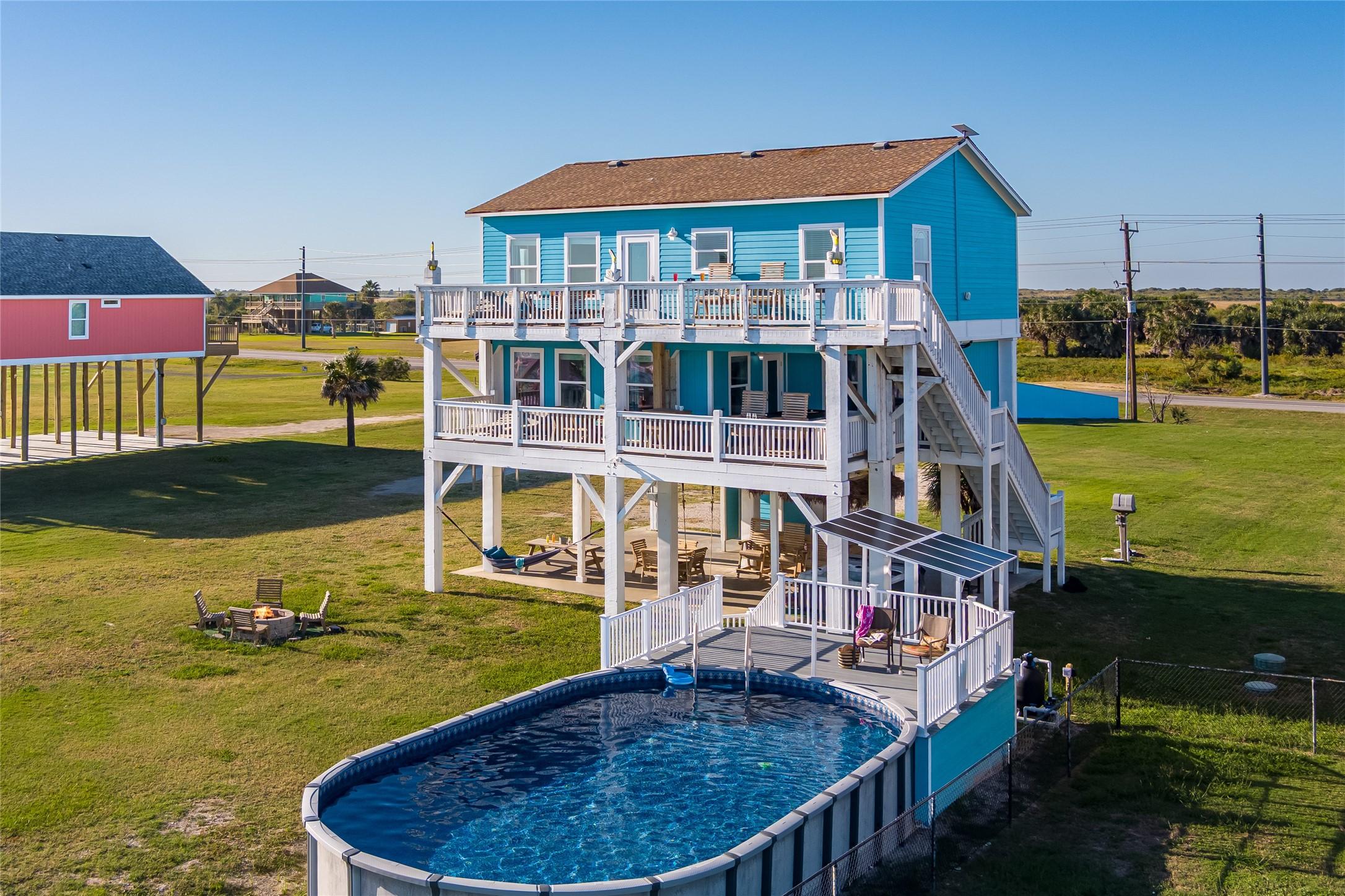 Image 1: Aerial view of the beach side of the house.