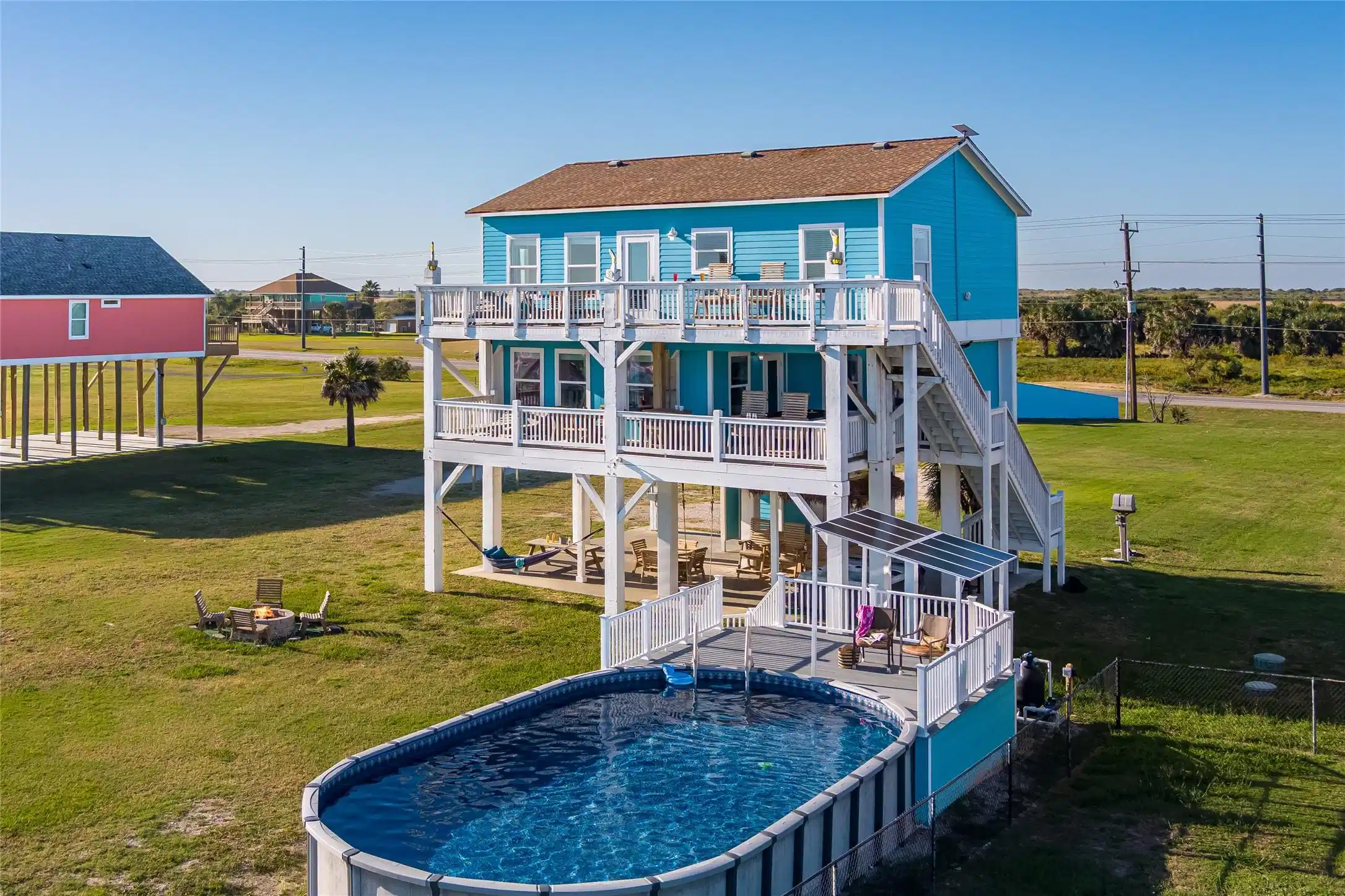 Image 1: Aerial view of the beach side of the house.