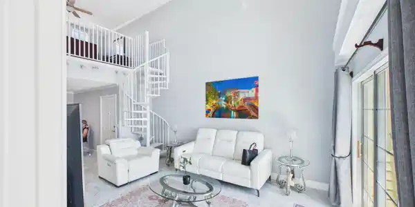 Image 3: High Ceilings with Spiral Staircase Leading to a L