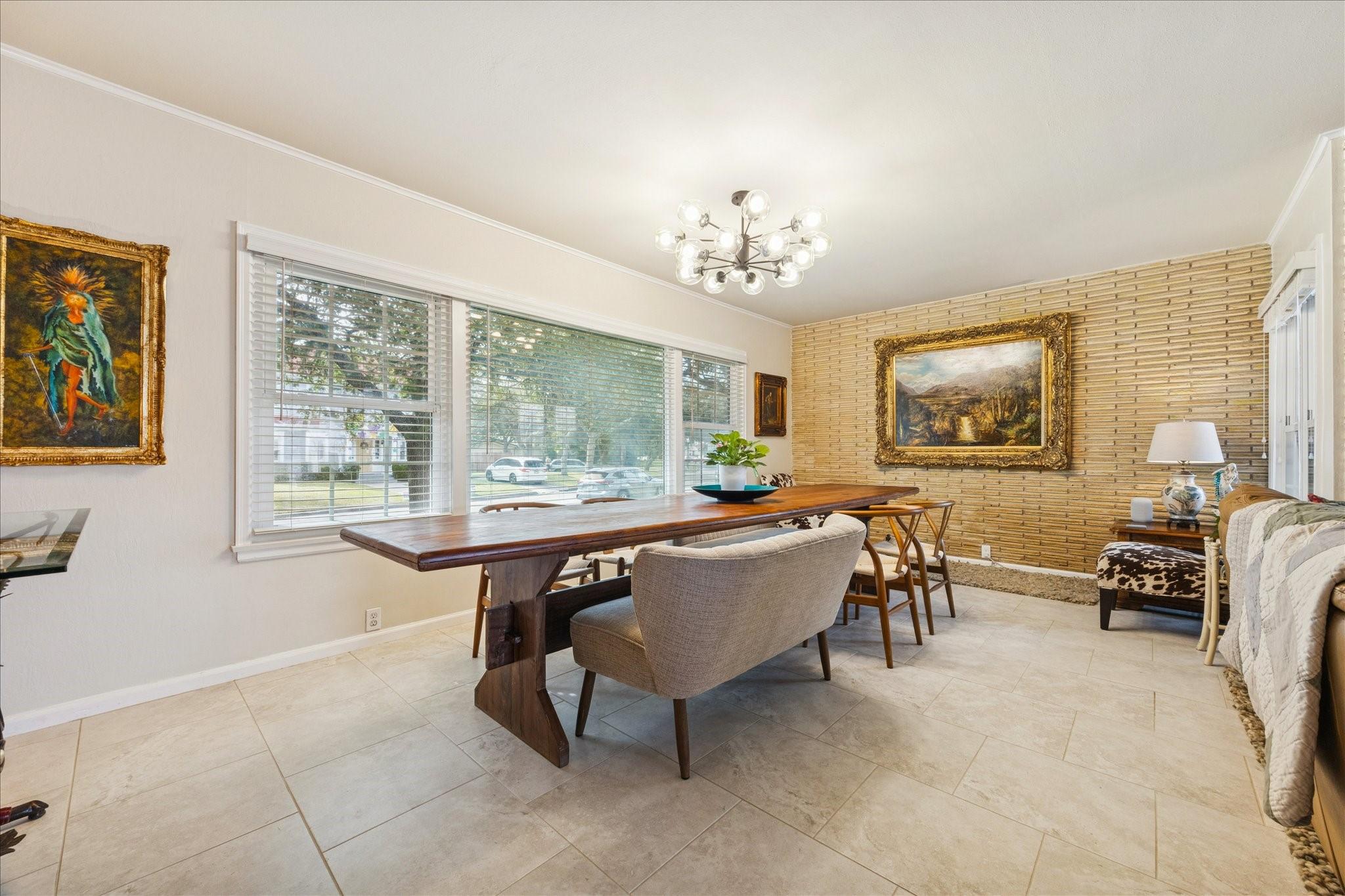 Image 3: This bright dining area features a brick accent wa