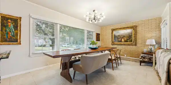 Image 3: This bright dining area features a brick accent wa