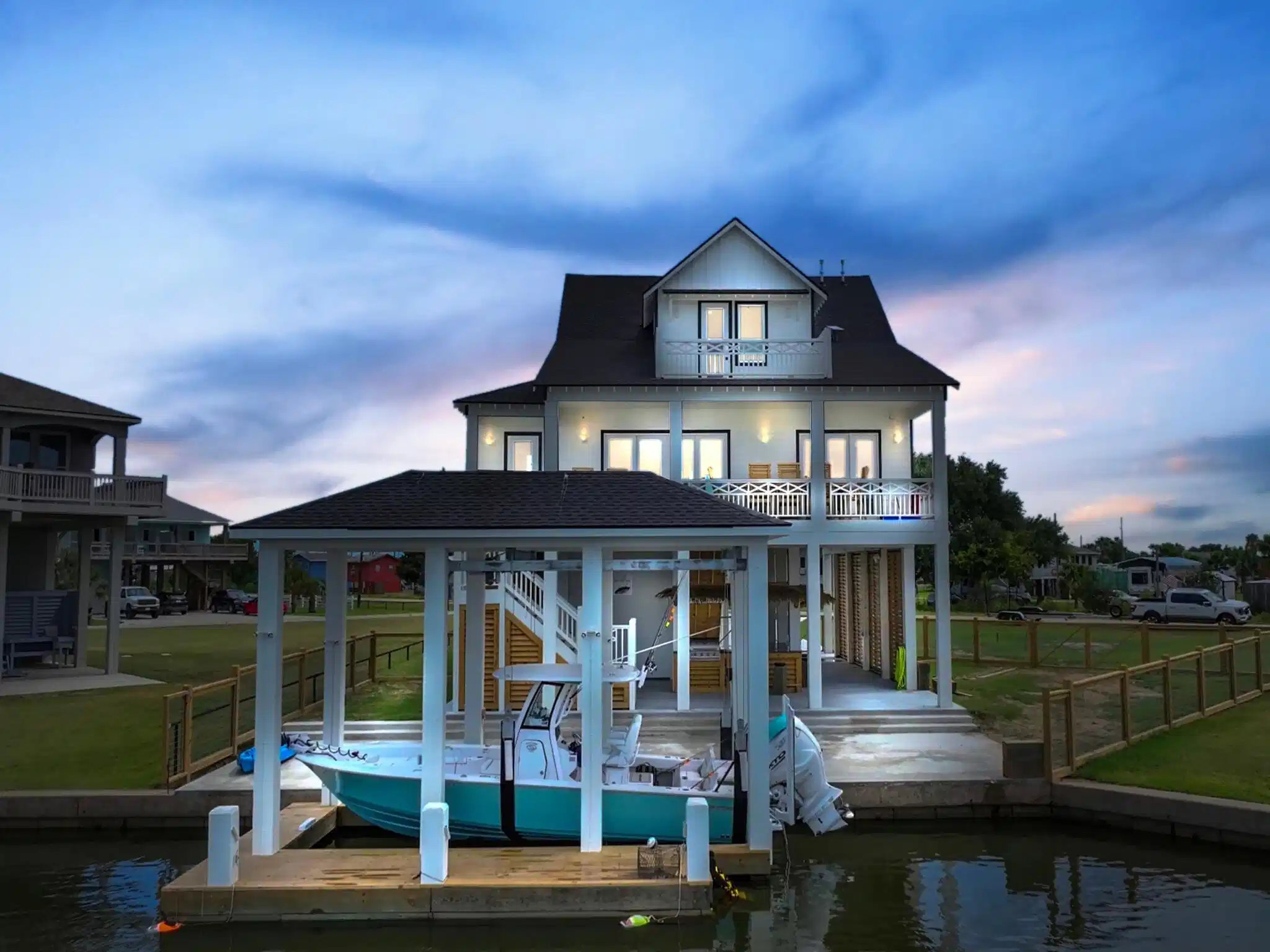 Image 1: View from the water of the house and boat lift. (B