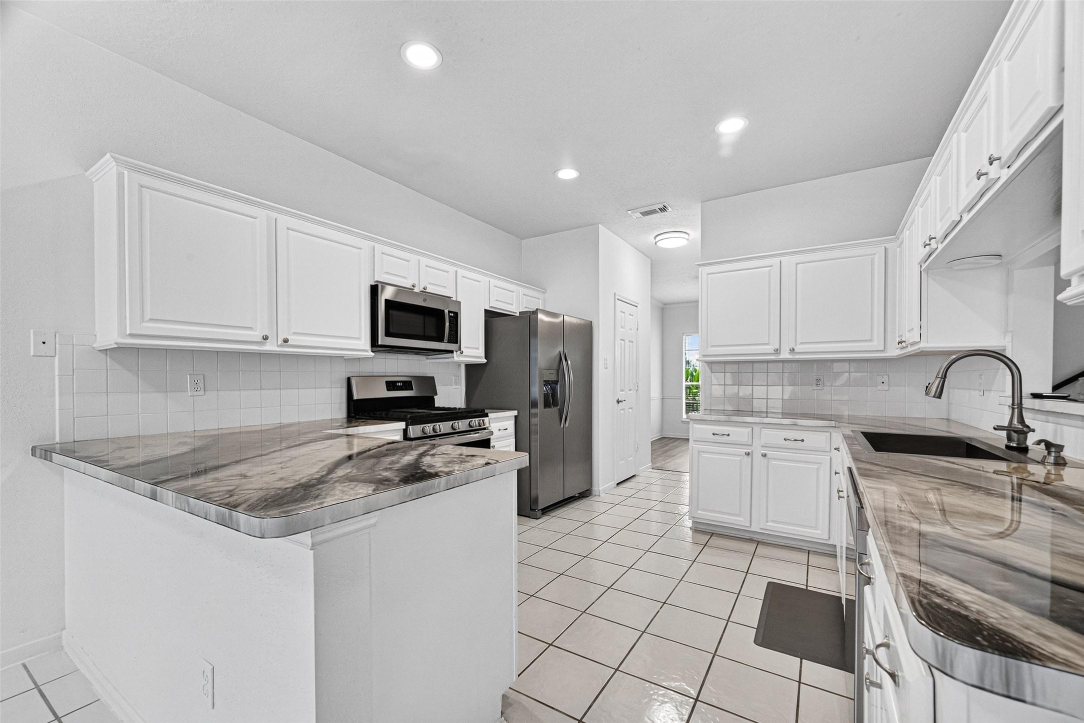 Image 2: Gorgeous kitchen with stainless steel appliances.