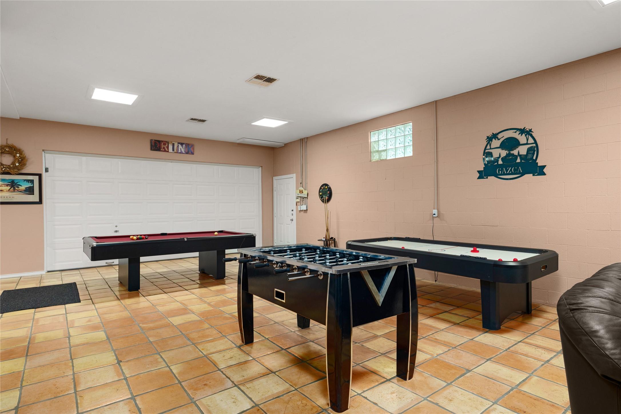 Image 4: This spacious game room features saltillo tile flo