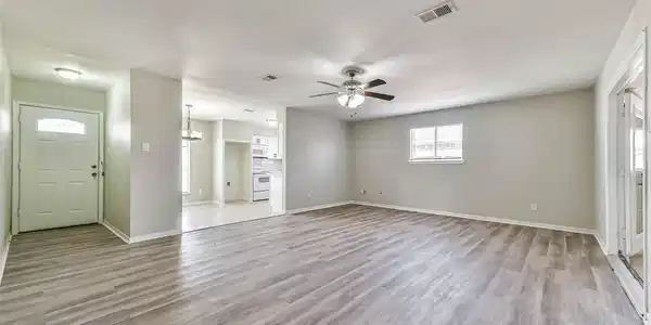 Image 3: View of living room and front door.