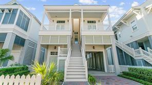 Image 1: This charming coastal-style home features an eleva