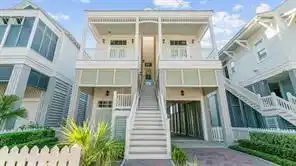 Image 1: This charming coastal-style home features an eleva