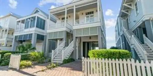 Image 2: This charming two-story home features classic coas