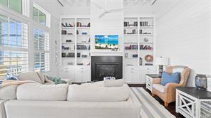 Image 4: This bright and airy living room features high cei