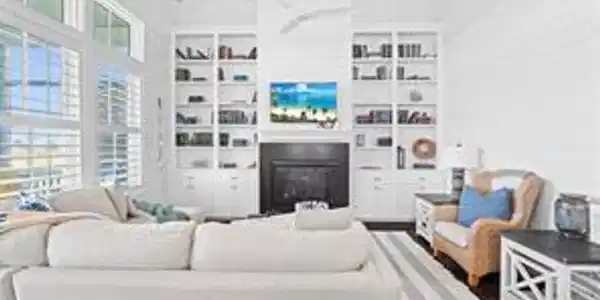 Image 4: This bright and airy living room features high cei
