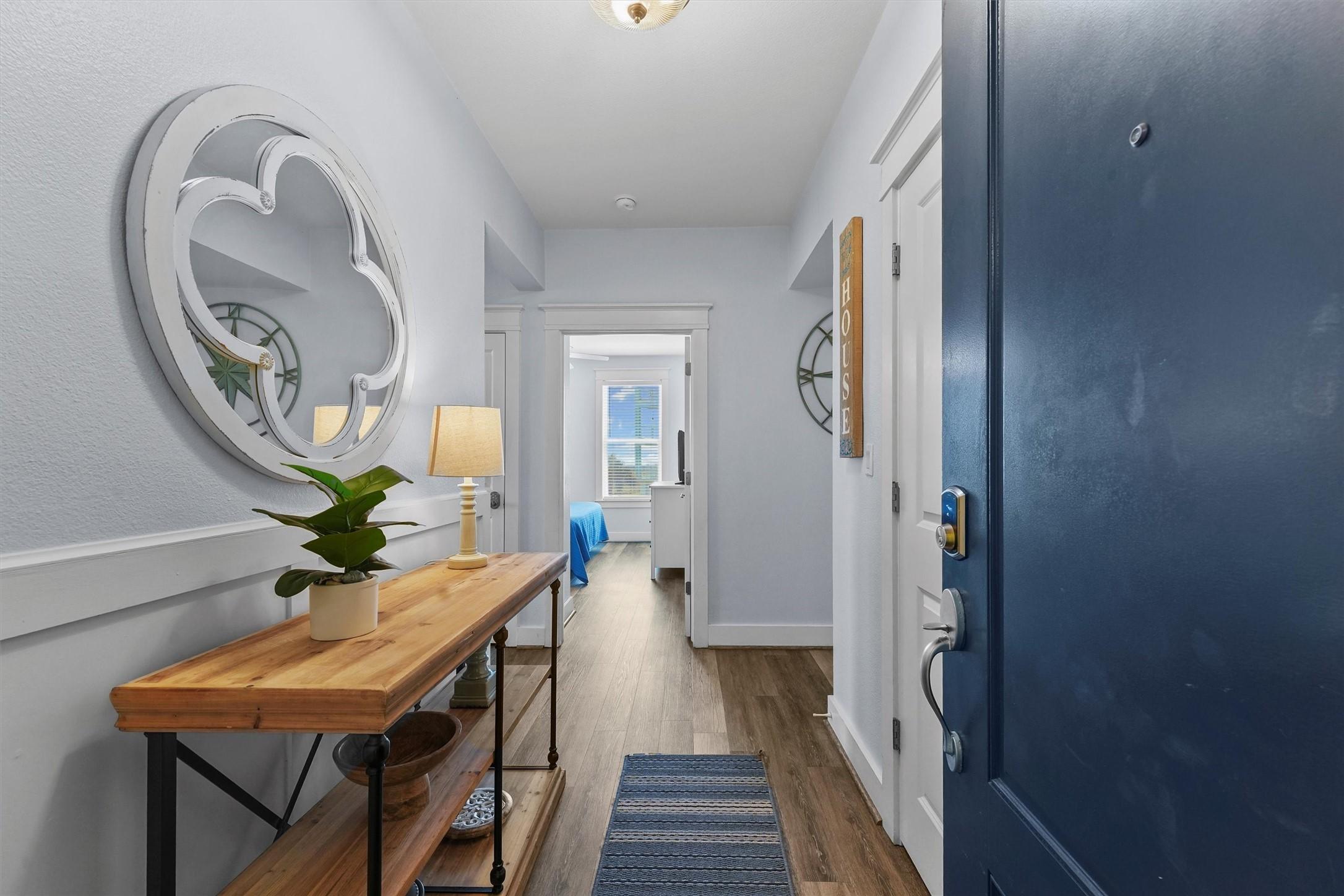 Image 4: A bright, inviting foyer leads the way inside, fea