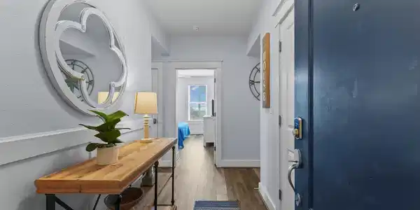 Image 4: A bright, inviting foyer leads the way inside, fea