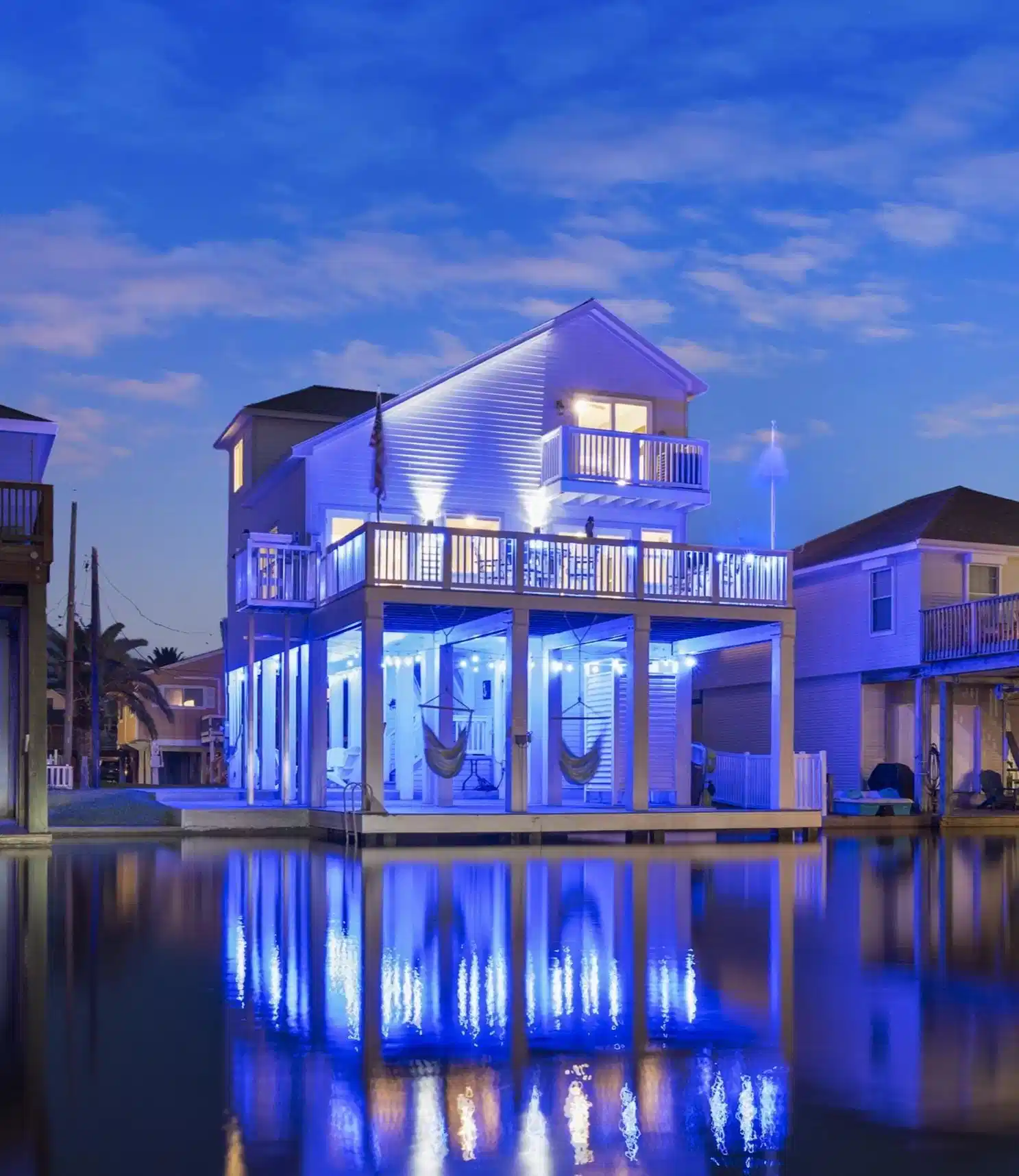 Image 1: View of the property at night w blue LED lighting