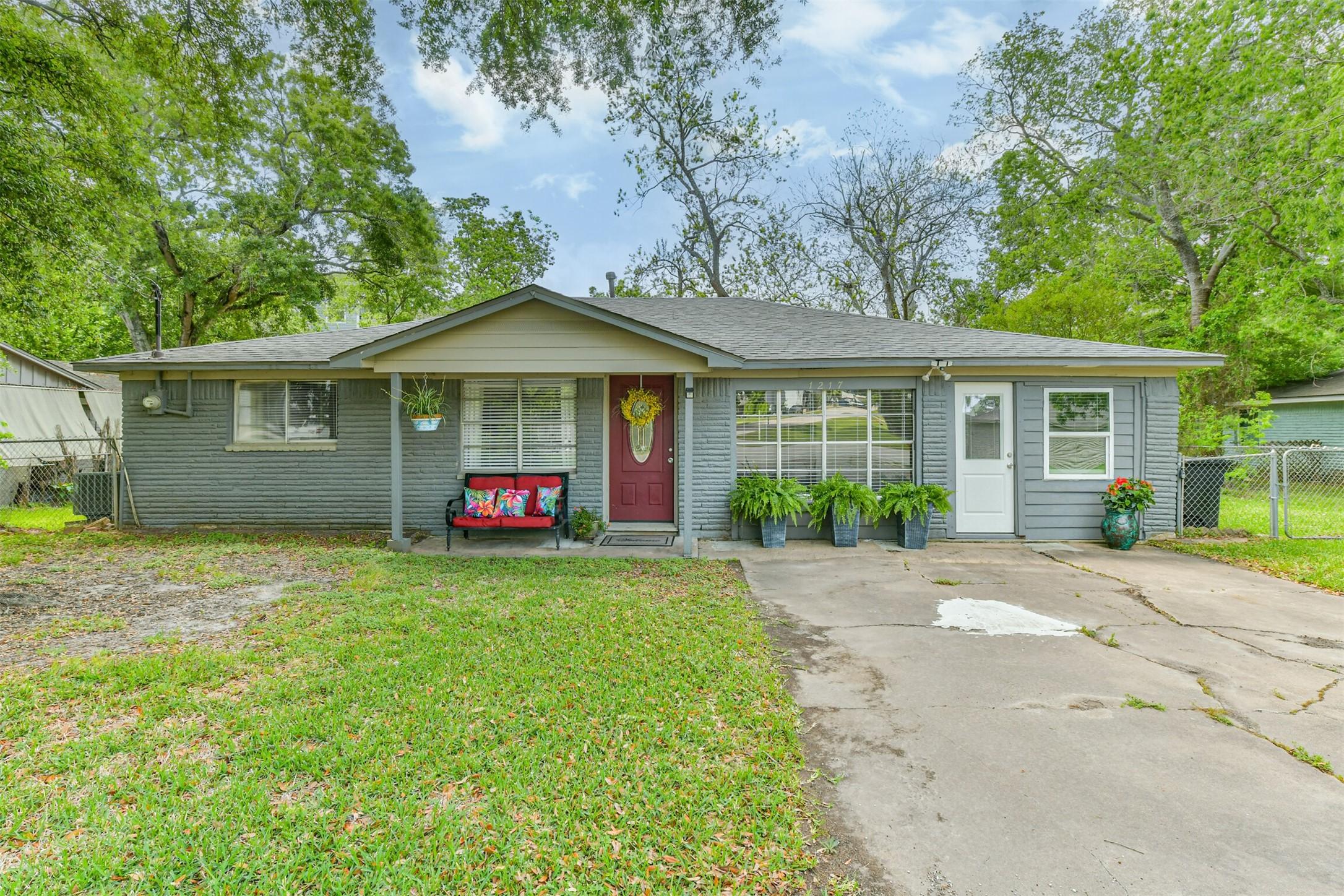 Image 1: This charming single-story home features a welcomi