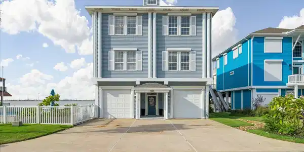 Image 2: Charming coastal home featuring a classic blue ext