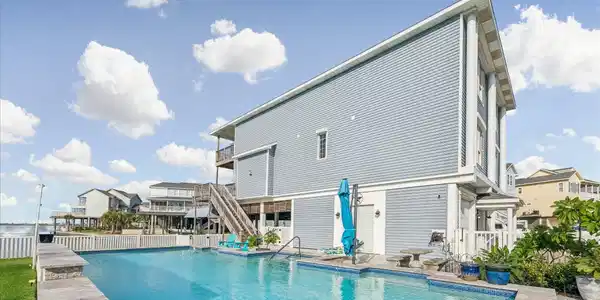 Image 4: MASSIVE pool includes a beautiful waterfall featur