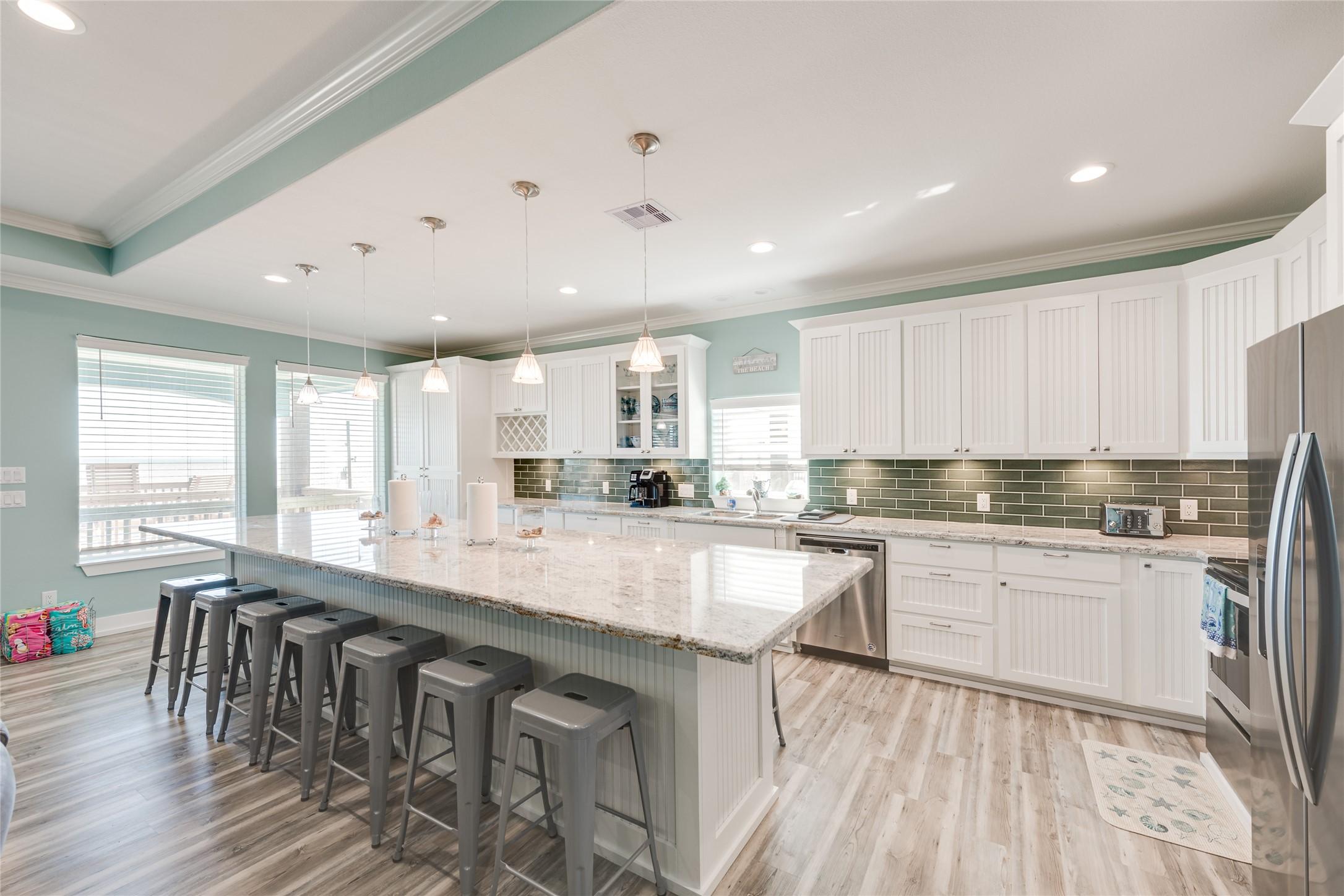 Image 4: Main kitchen has huge island for hosting.