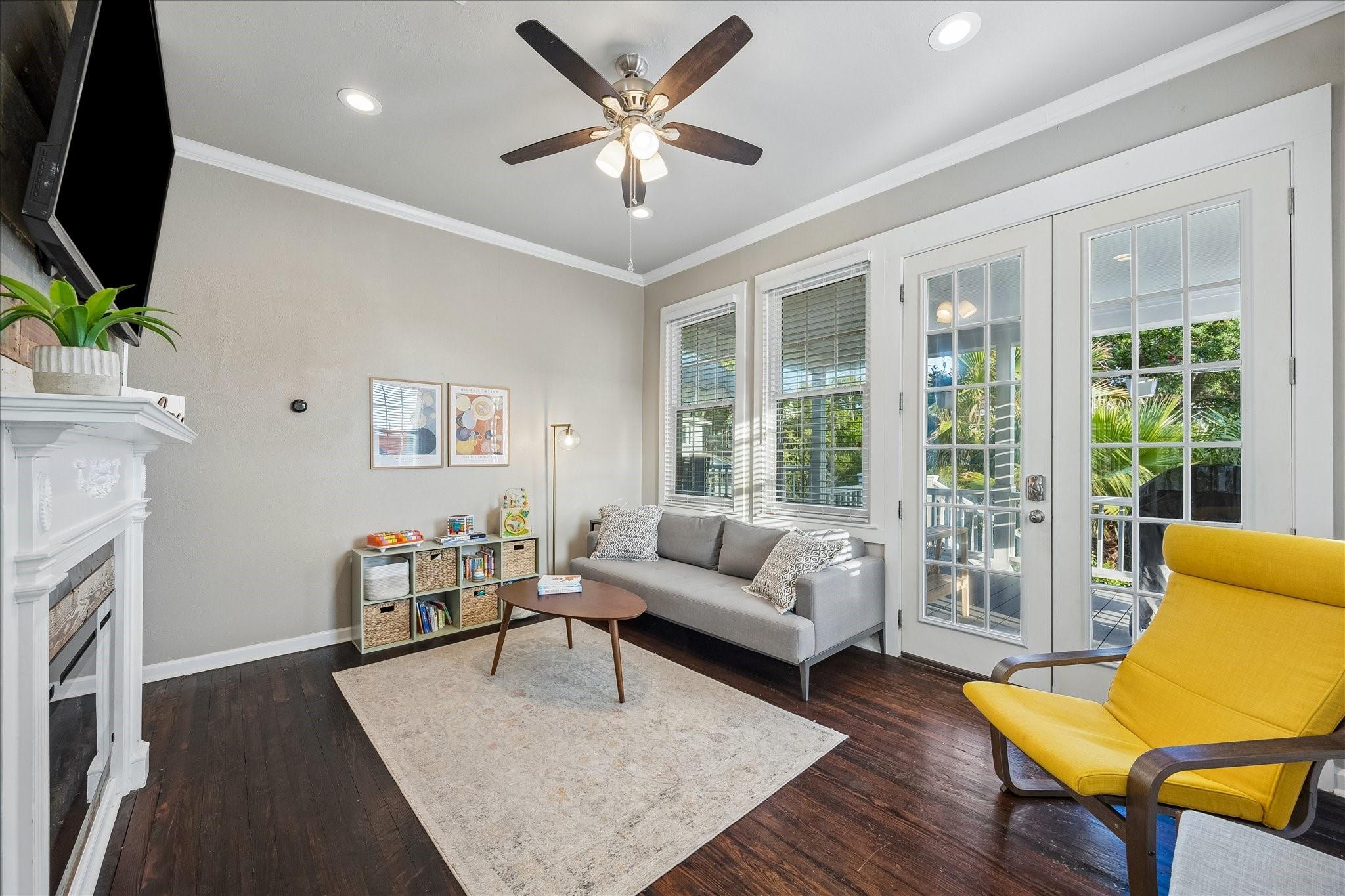 Image 2: Light filled living area with fireplace.