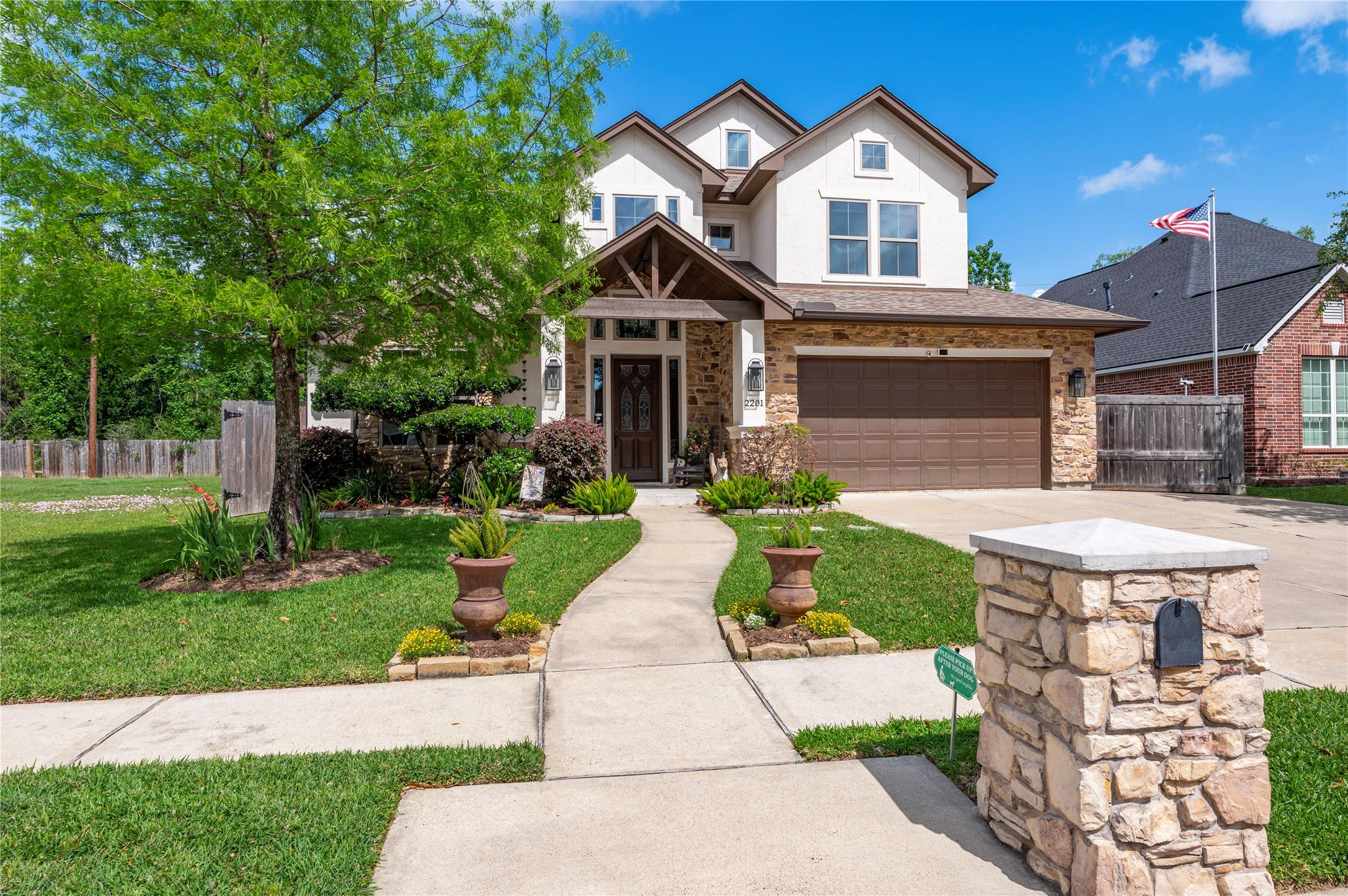Image 3: This photo showcases a beautiful two-story home wi