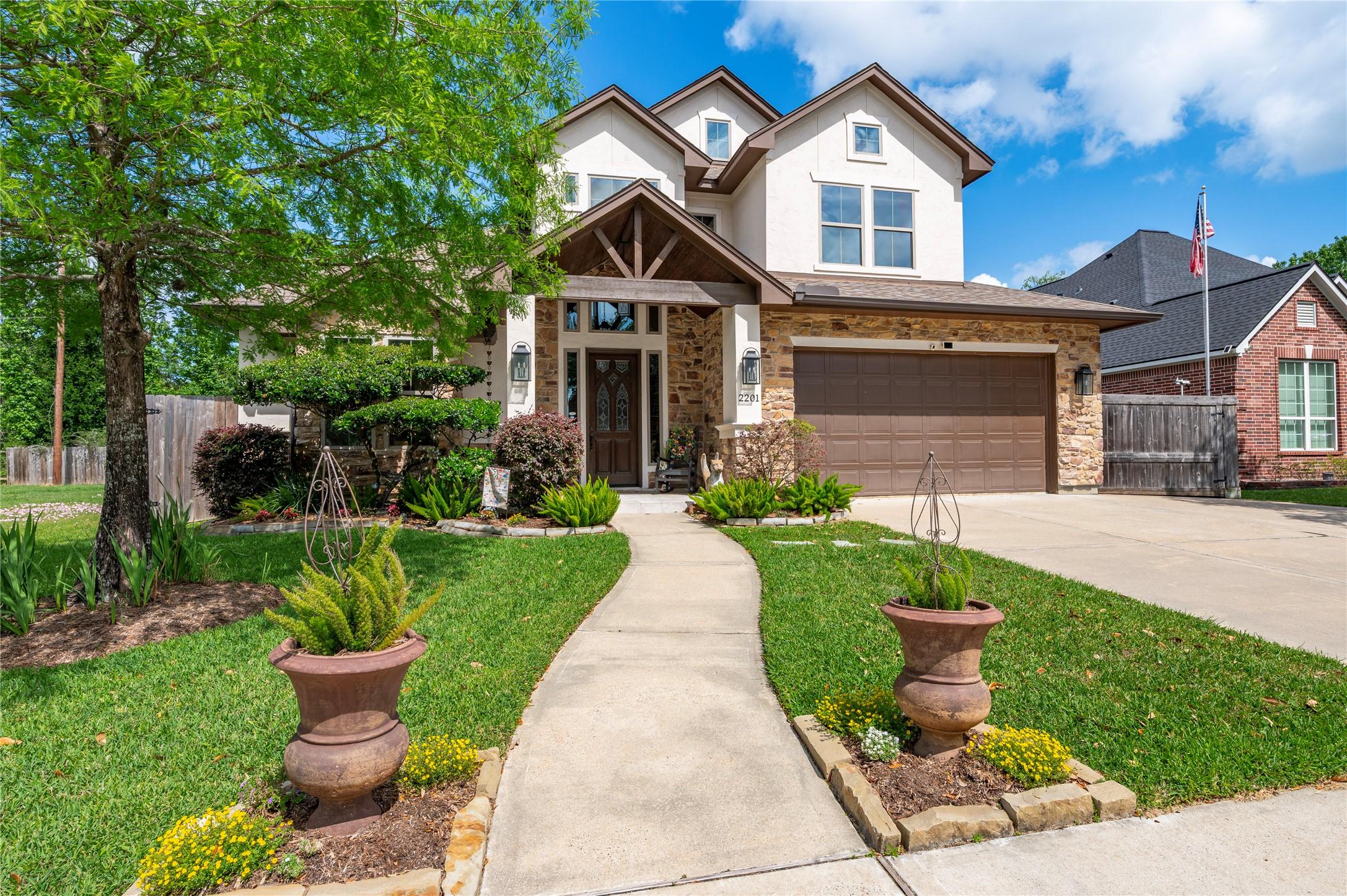 Image 4: This photo showcases a charming two-story home wit