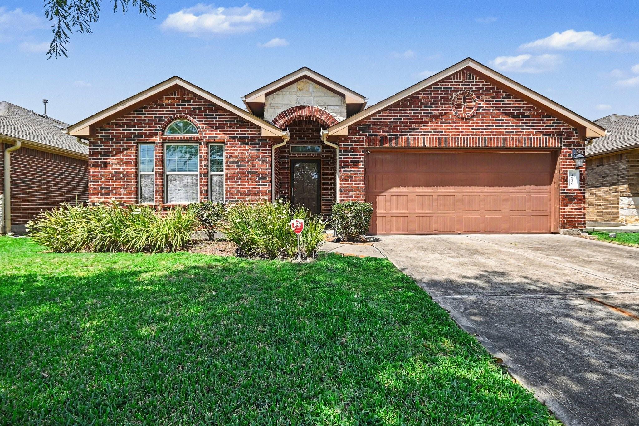 Image 2: This brick home boasts a warm and inviting covered