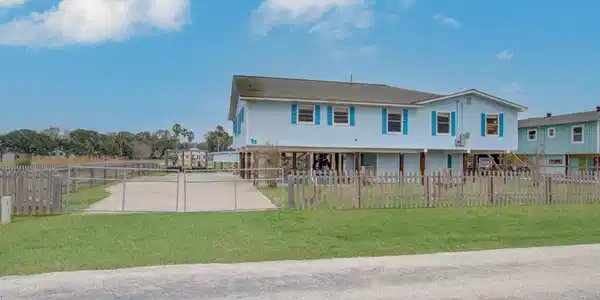 Image 2: Raised for ease and appeal, the home includes a ga