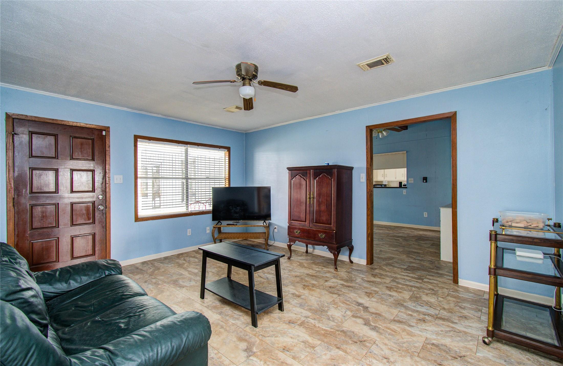 Image 4: Bright, inviting living space featuring polished f