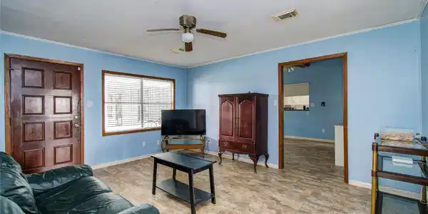 Image 4: Bright, inviting living space featuring polished f