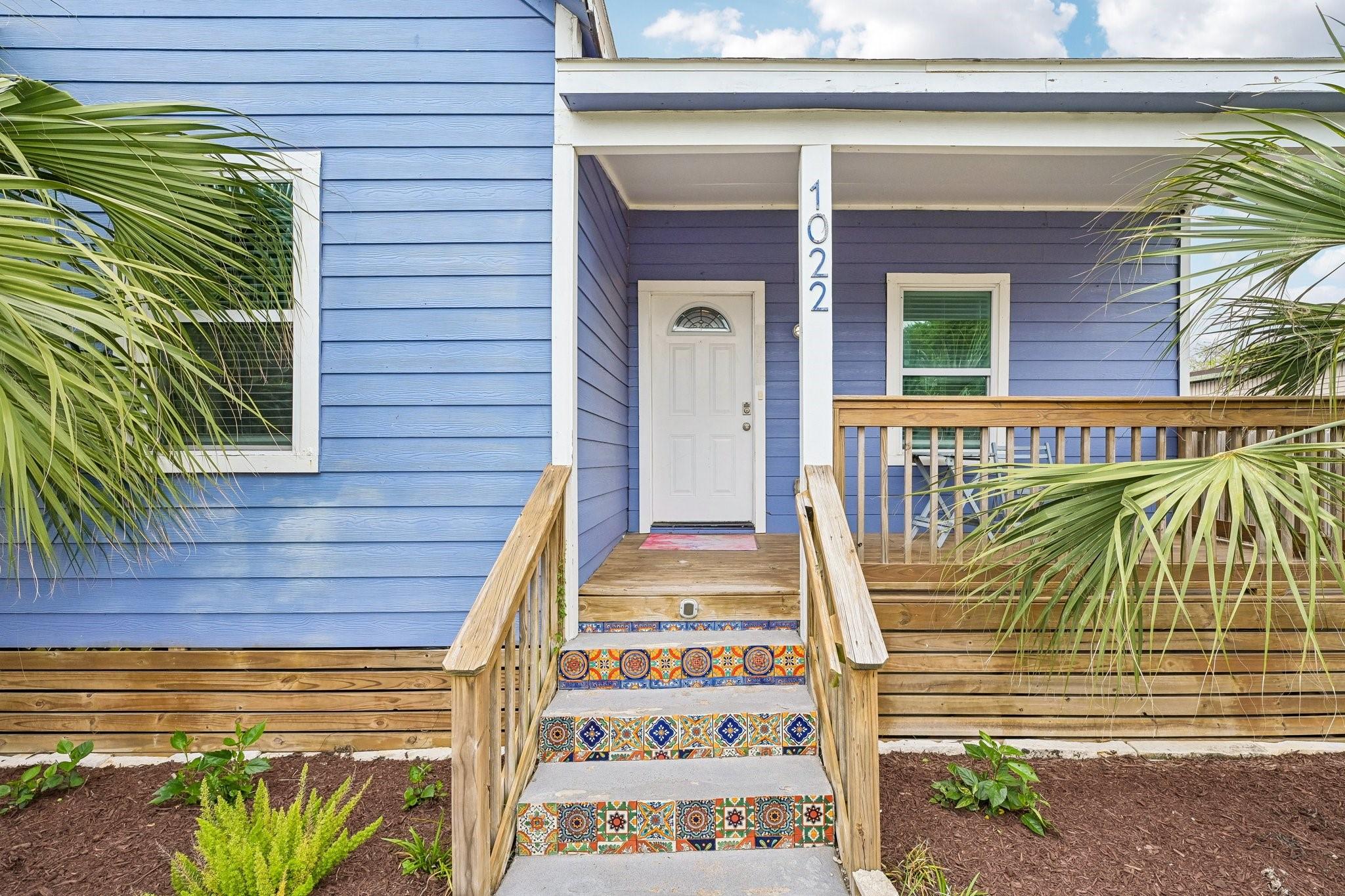 Image 3: Welcoming front entry with a covered porch and woo