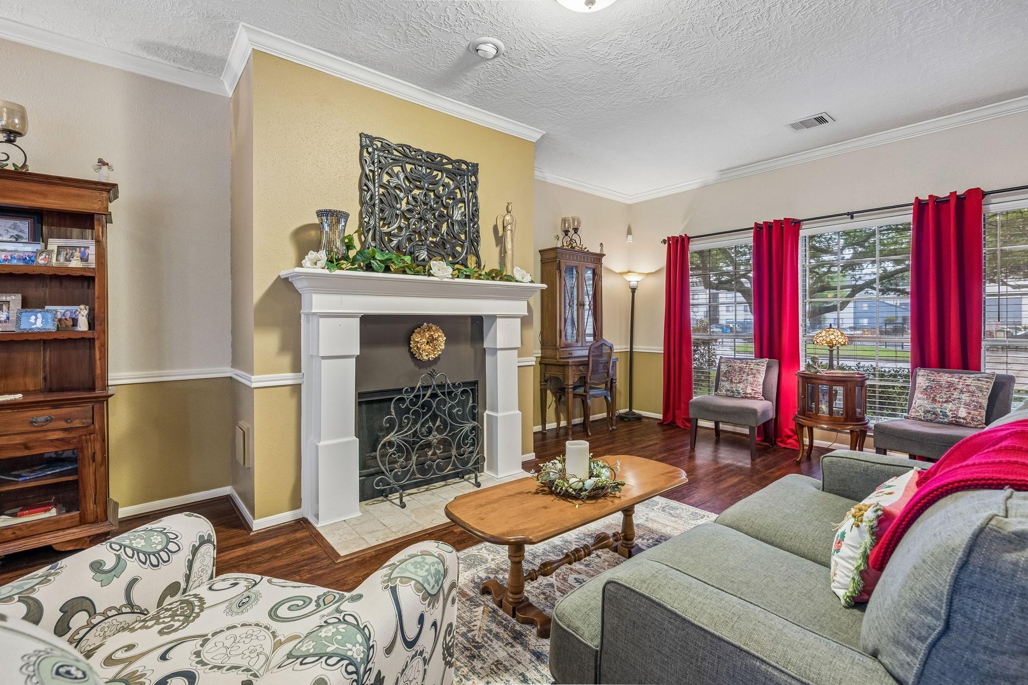 Image 4: This cozy living room features a warm, inviting fi