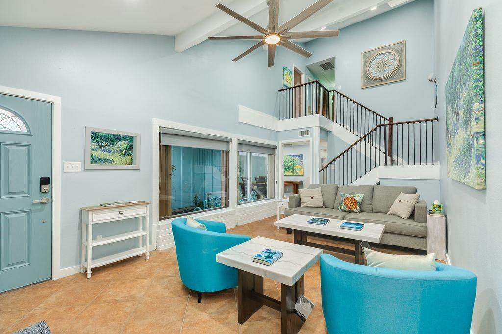 Image 3: Enter into the living room with high vaulted ceili