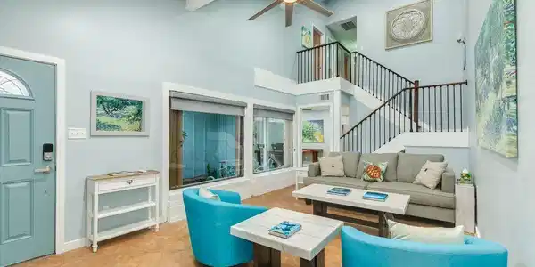 Image 3: Enter into the living room with high vaulted ceili