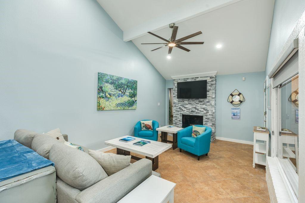 Image 4: LR:  Fireplace with beautiful tile, ceiling fan, a